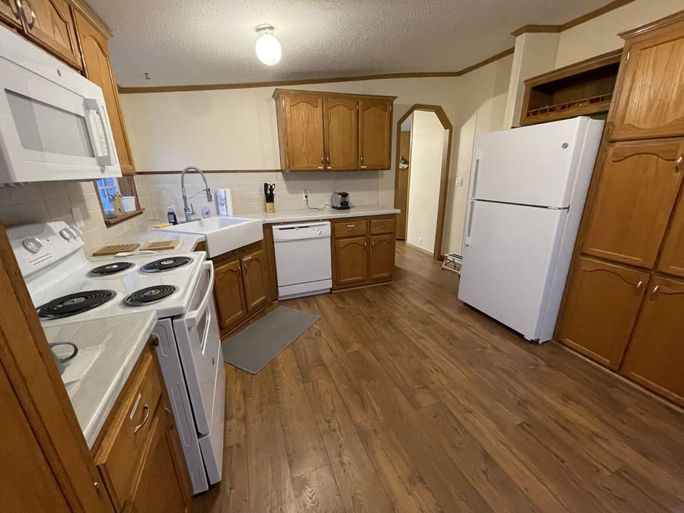 Kitchen with oven/range, microwave, dishwasher and fridge and lots of storage