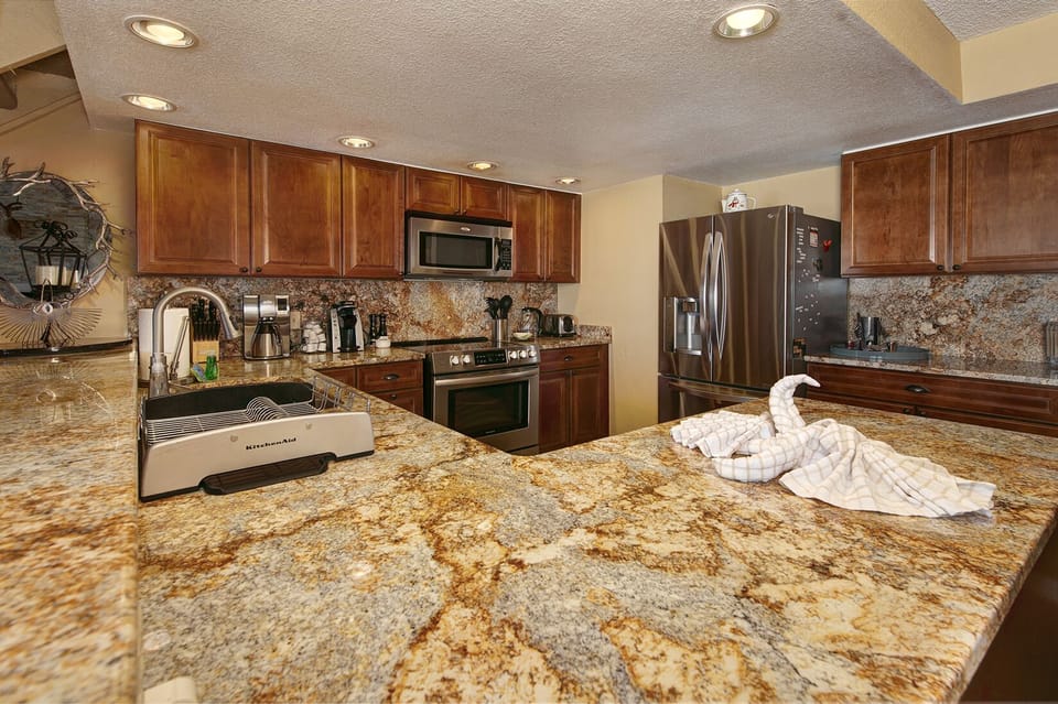 Full kitchen with stainless steep appliances.