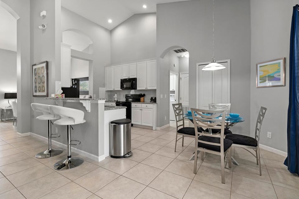Kitchen and seating space.  Pantry door is behind the seating area.
