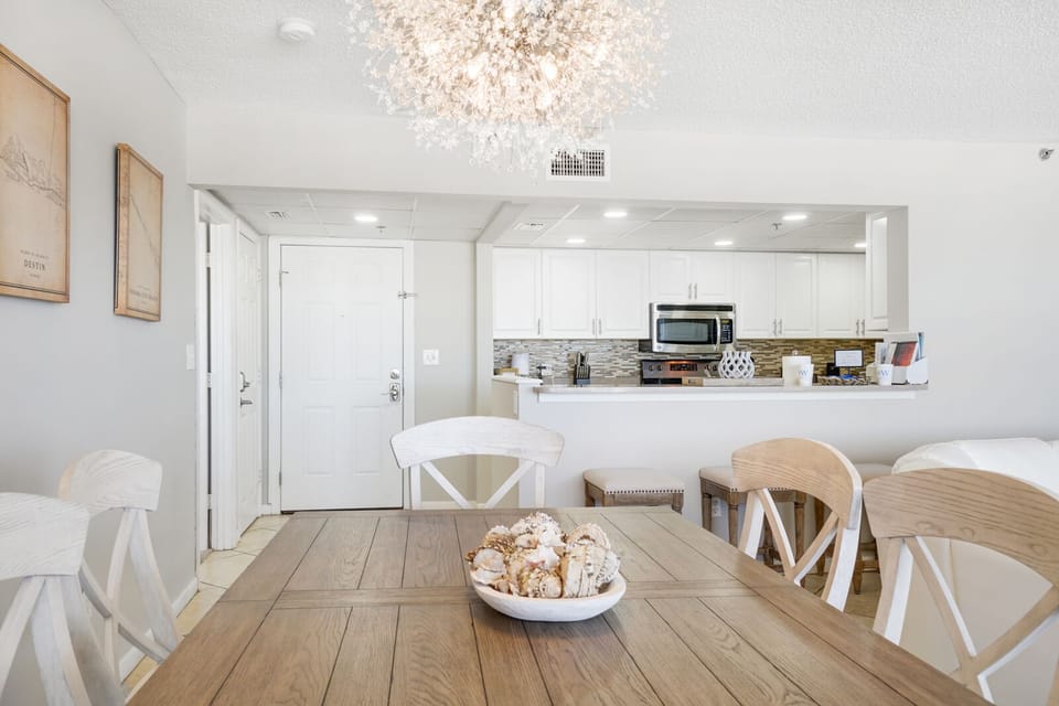 You'll love gathering around this beautiful dining table under the sparkling chandelier, with your fully equipped kitchen just steps away.