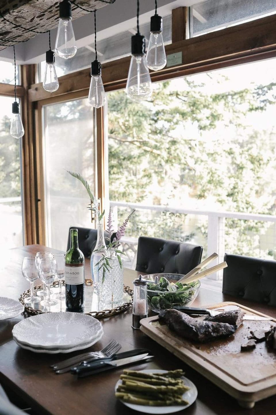 Sliding doors open for summer days, inviting the fresh breeze off of the water and creating an outdoor dining experience.