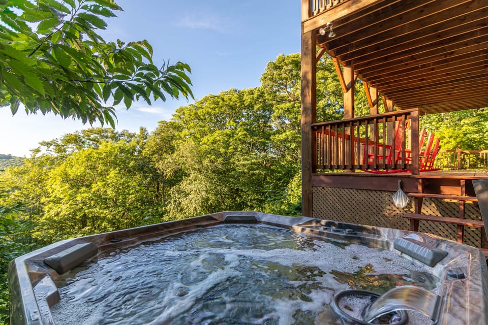 Soak in the hot tub while lush Blue Ridge treetops stretch out in every direction. Pure mountain bliss at Whispering Ridge Retreat.