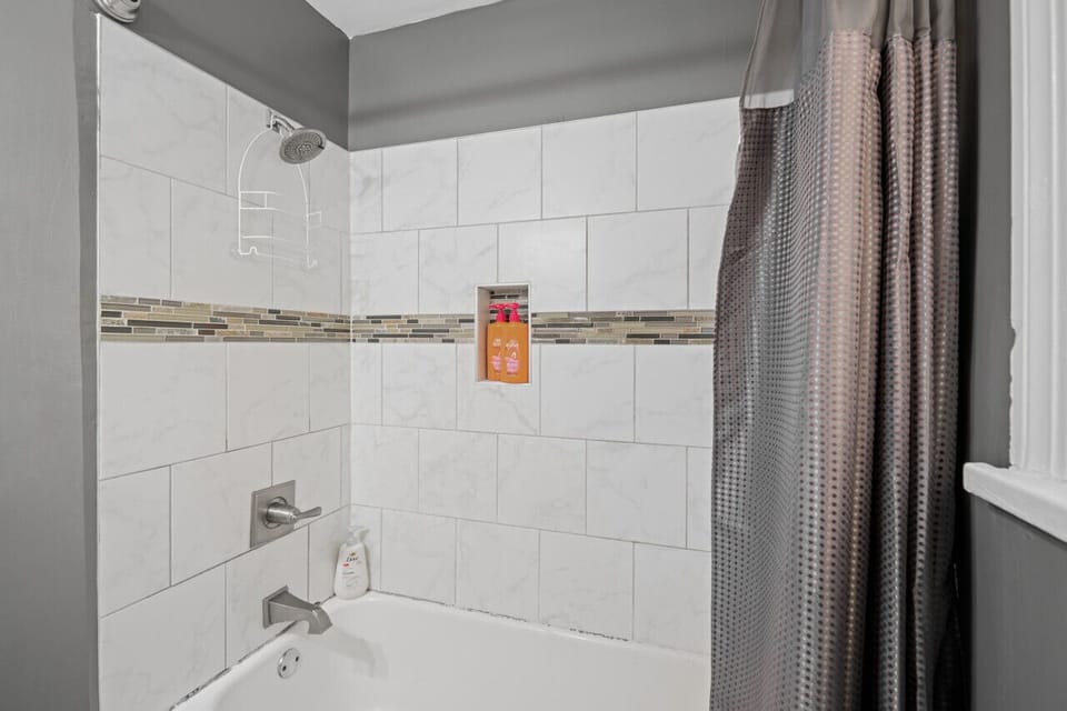 Convenient and stylish, this bath/shower combo features a vanity mirror—your go-to spot to freshen up on the first floor.