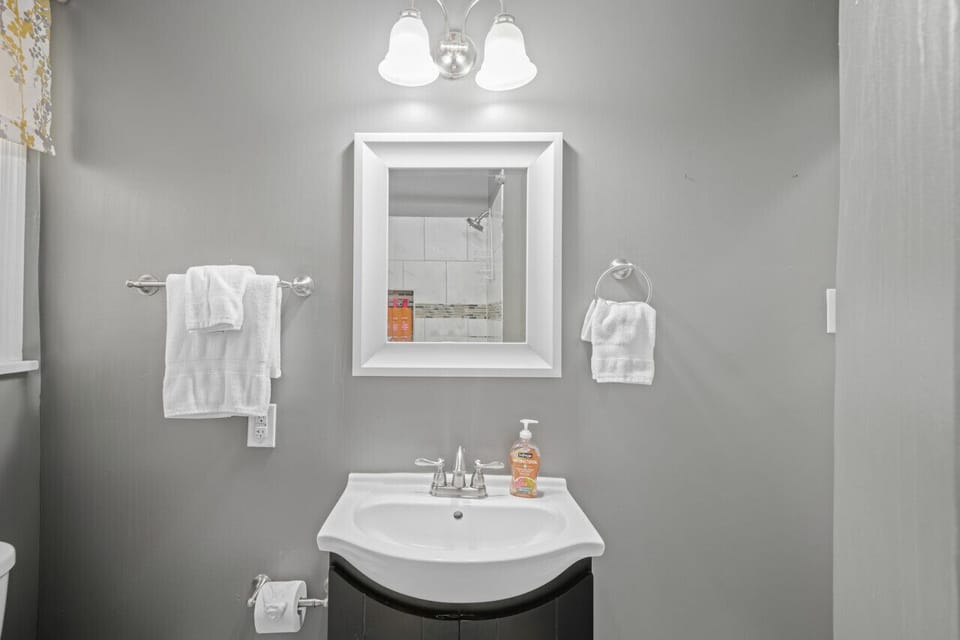 Convenient and stylish, this bath/shower combo features a vanity mirror—your go-to spot to freshen up on the first floor.