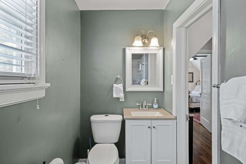 Spa vibes await! A walk-in shower with tiled floors and soothing tones make this the perfect place to unwind.