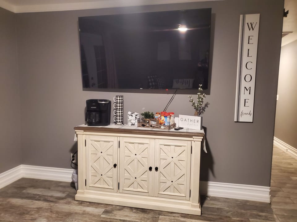 Master bedroom suite coffee bar and 65" smart tv