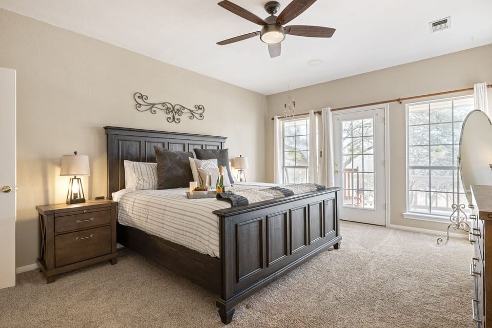 Main Level Master Bedroom with a King Bed and Patio Access