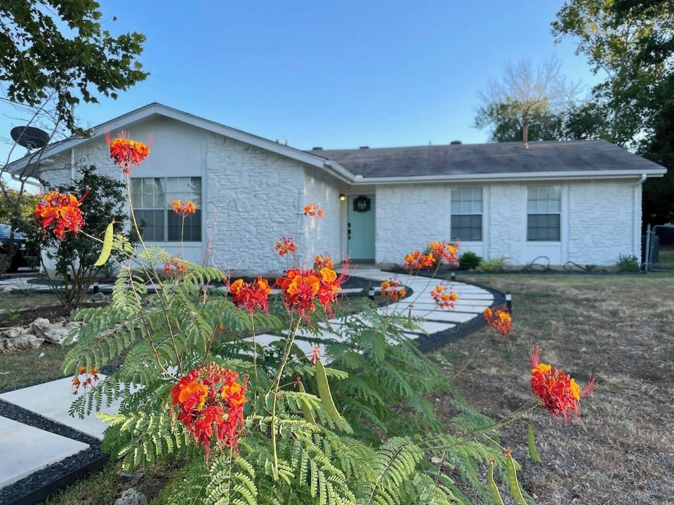 Seasonal landscaping pops up to say hello! Our home is easily recognizable as it is white. Look for parking on the left side of the house. 