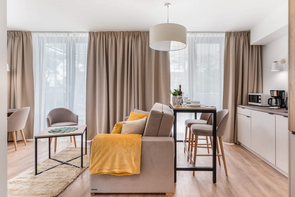 Cosy and stylish space that combines a seating area with a dining area. In the background is the kitchenette.
