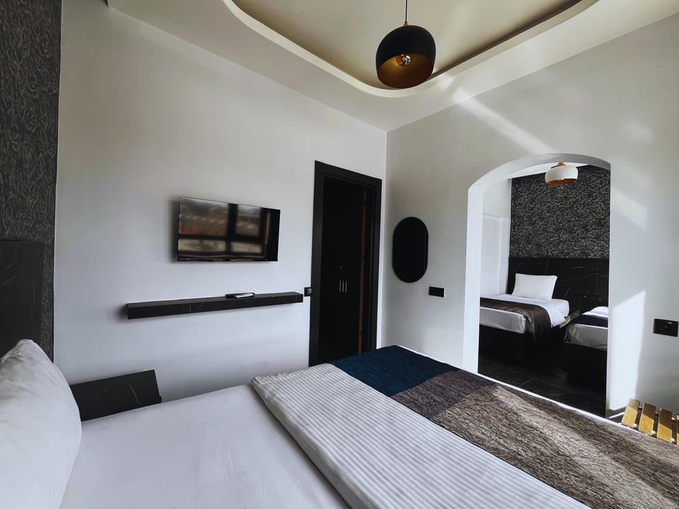 Deluxe Quadruple Room, City View | Soundproofing, WiFi (free), bed sheets