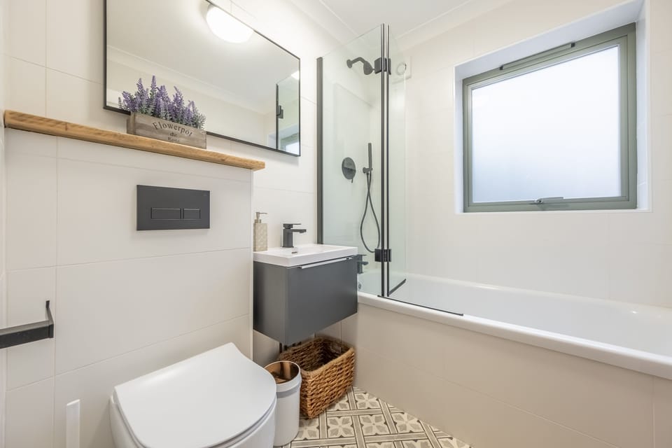Ground floor: Bathroom with bath and shower over, wash basin and WC