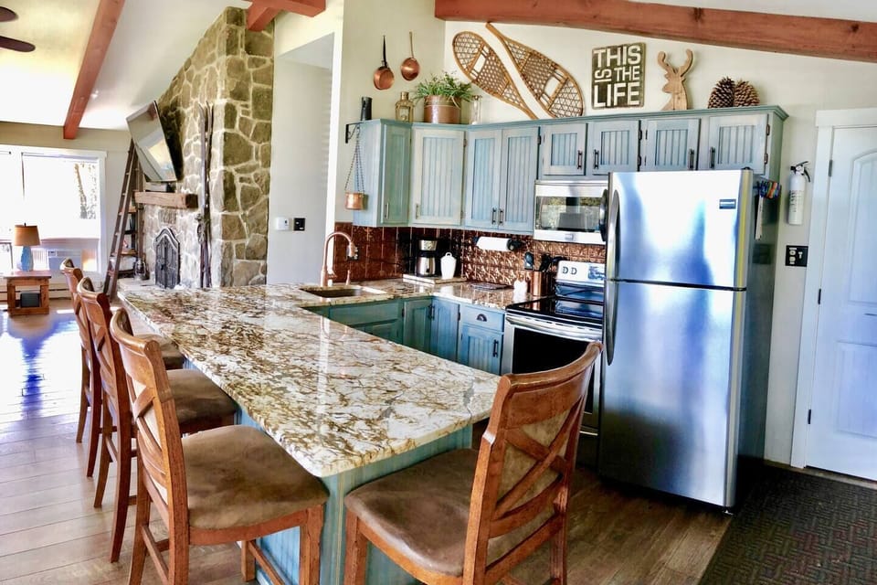 Custom granite, hand-finished cabinets, and artisan-crafted Pennsylvania flagstone wall