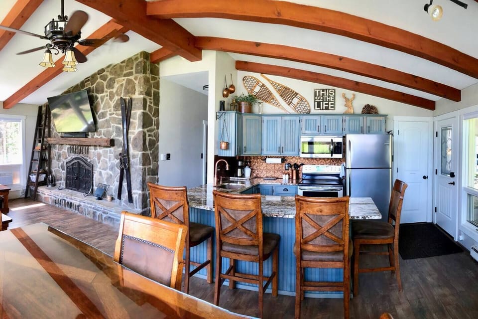 Swiss chalet charm with beamed ceilings and flagstone wall. 