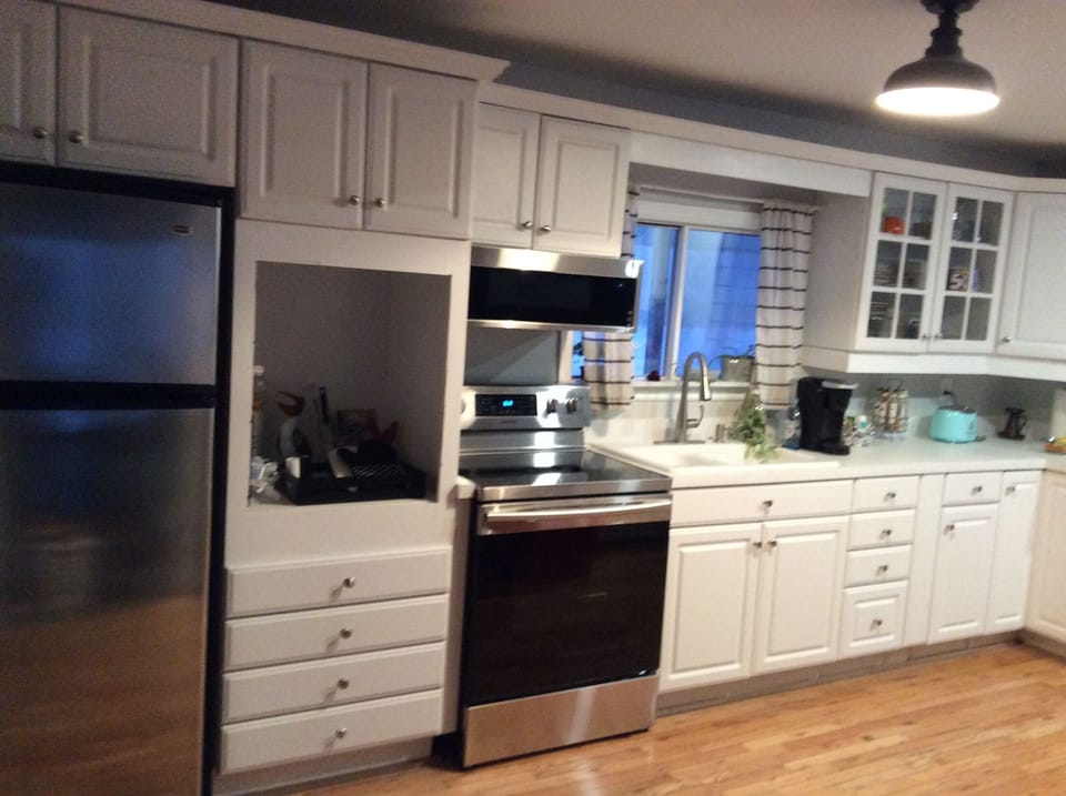 Kitchen: fridge, stove, microwave, Keurig, toaster, kettle, dishes, cutlery