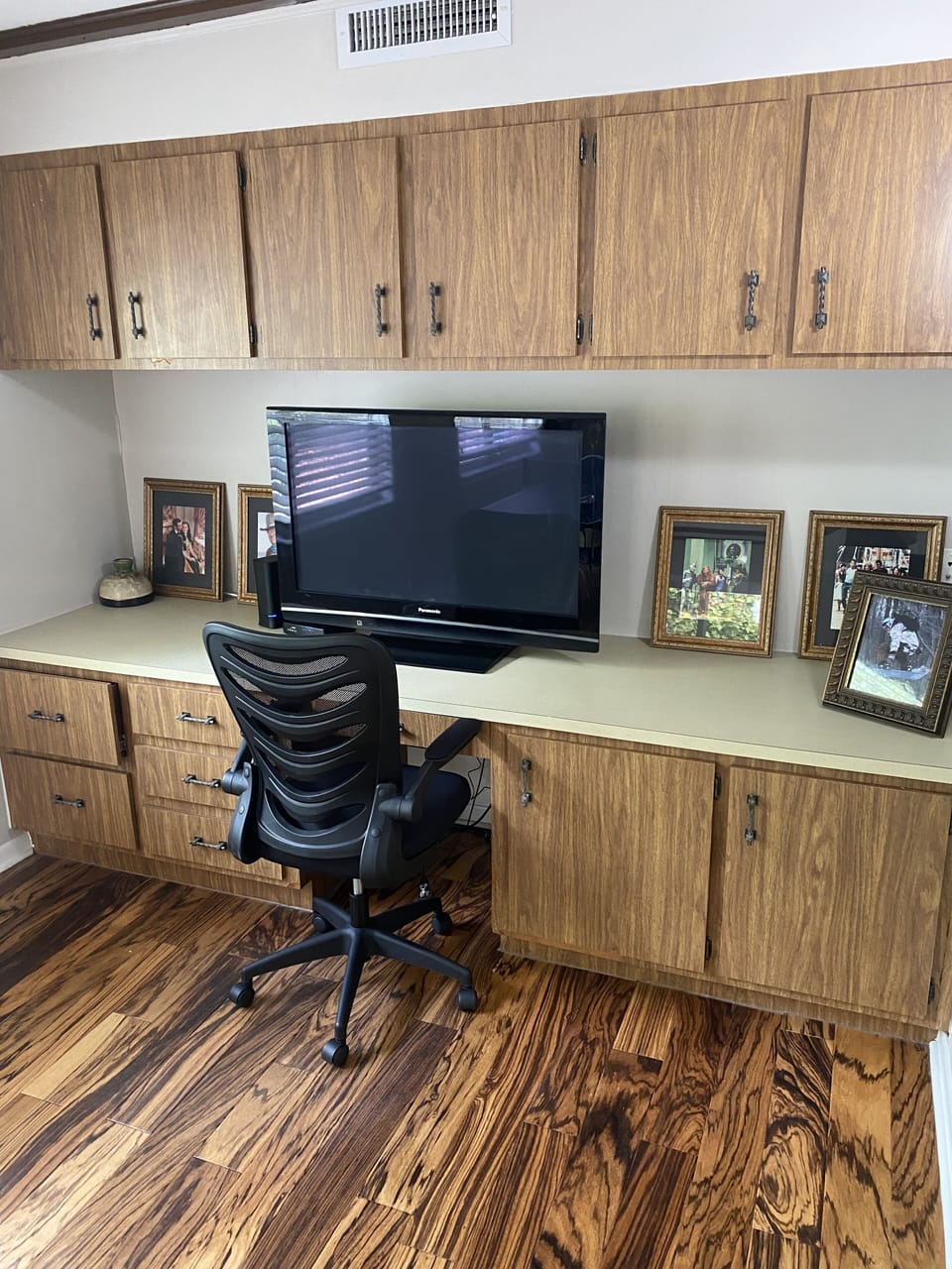 Desk with large computer monitor.  Just a monitor. 