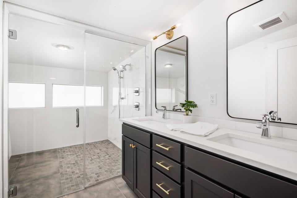 Primary bathroom includes two sinks, a soaking tub, and an enormous shower that will make every morning start off wonderfully.