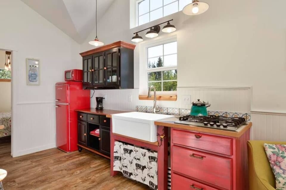 Adorable kitchen with cooktop.