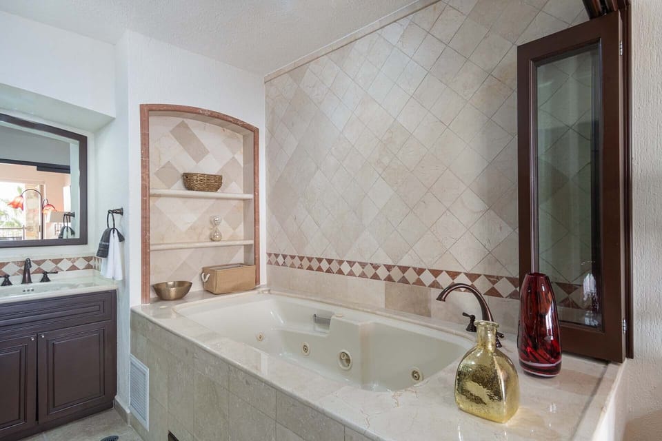 The main bedroom has its own tub. along with a shower and double vanity