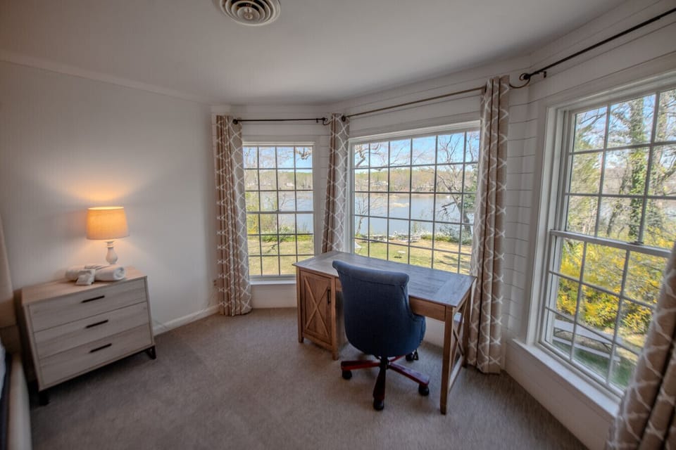 Luxe primary bedroom desk with water views