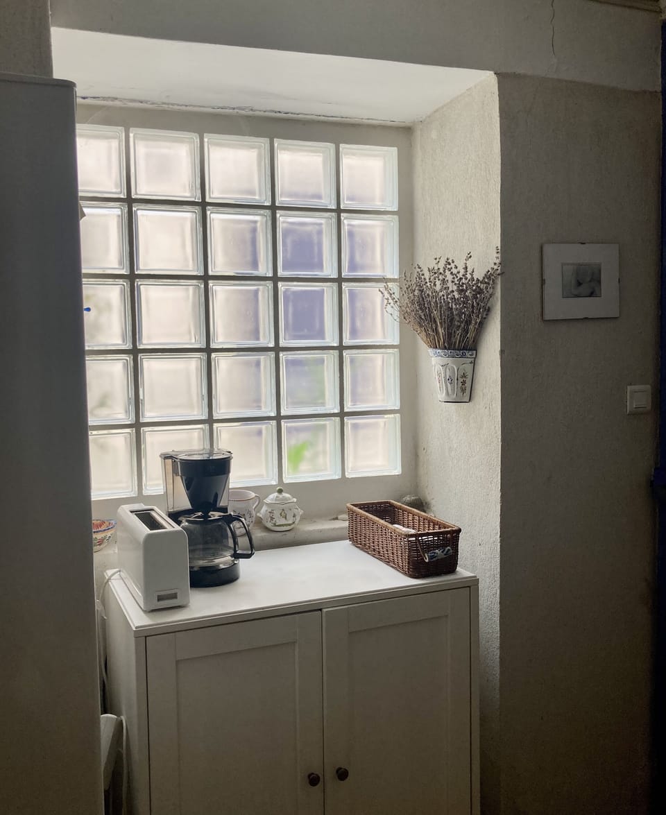one of the kitchen windows, showing coffee maker and toaster.
