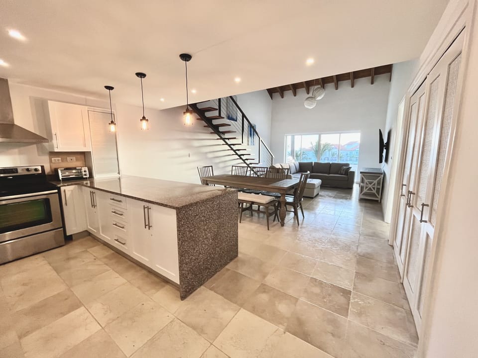 open kitchen, dining & living room with access to the balcony