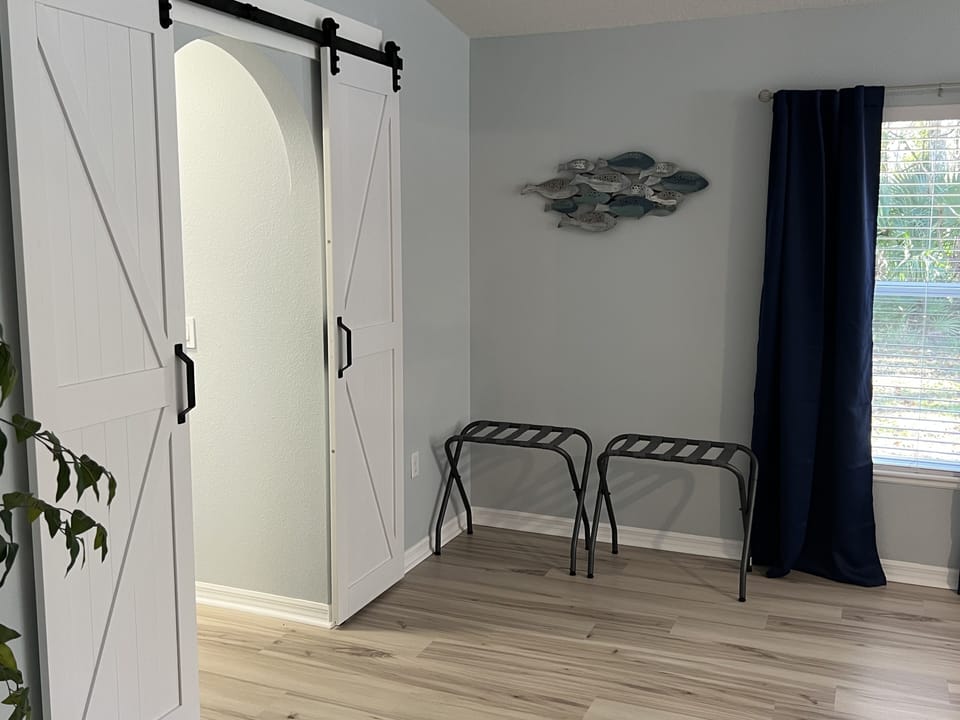 Master bedroom barn doors leading to two oversized closets and master en-suite.
