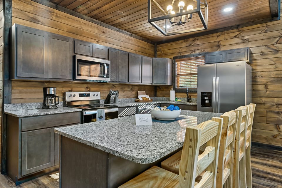 Fully-supplied kitchen with stainless steel appliances and granite countertops. 