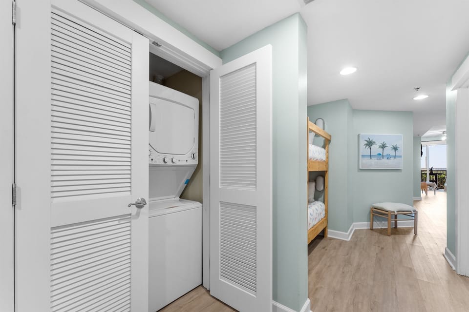 Your convenience is covered with stacked laundry units tucked behind stylish louvered doors, plus cozy bunk beds for extra guests.