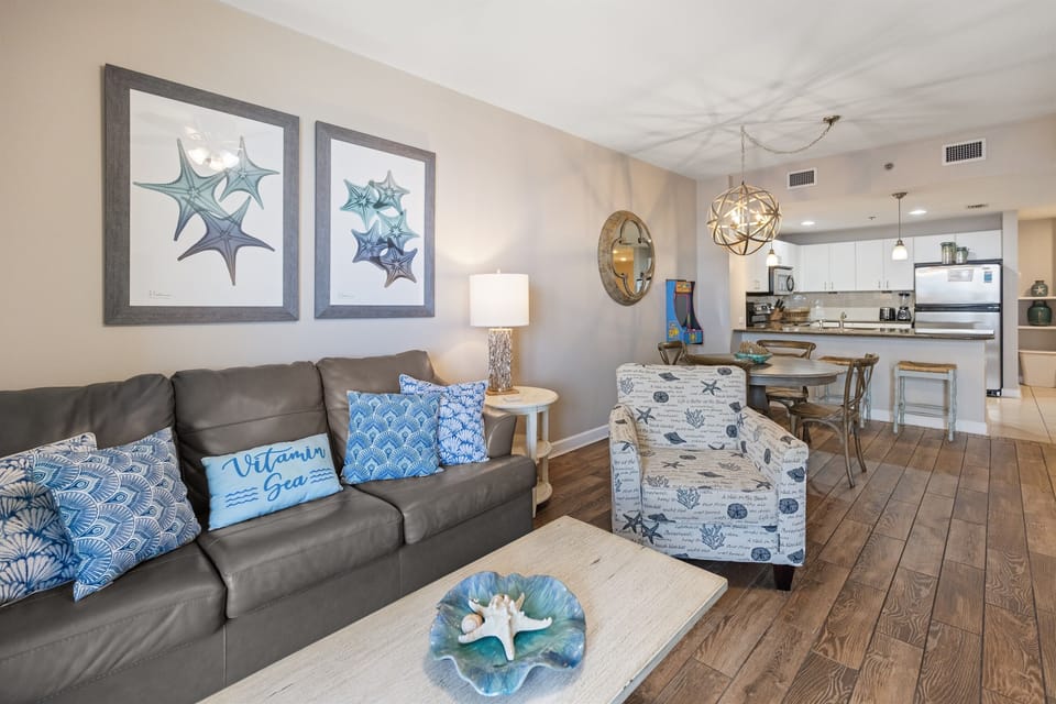 Unwind in your coastal-themed living space where ocean blues meet modern comfort, perfect for relaxing after beach days.