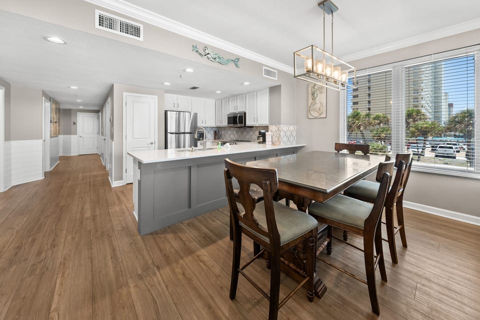 Your modern kitchen flows seamlessly into the dining area, featuring elegant finishes and city views perfect for memorable meals.