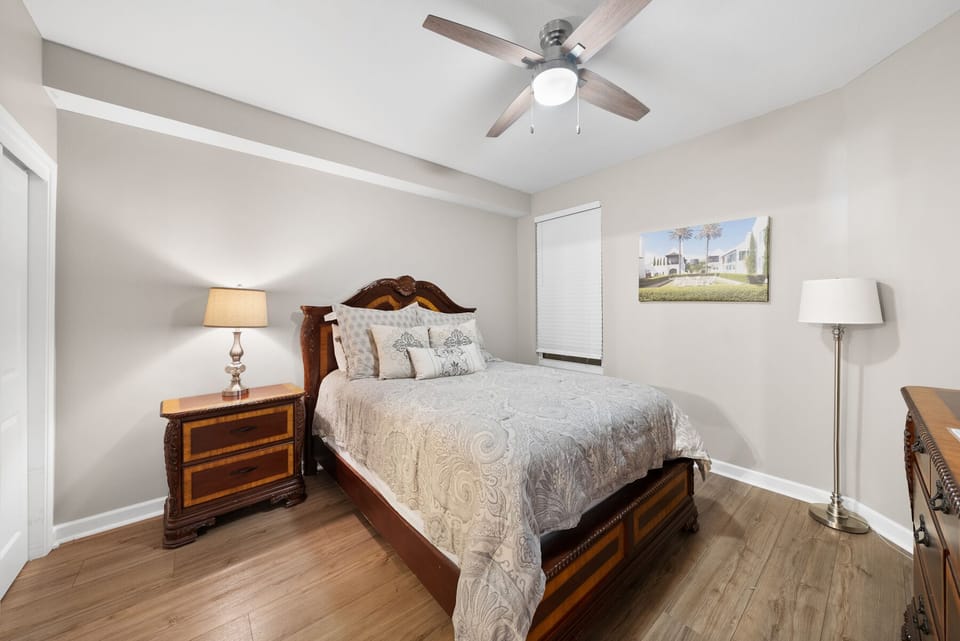 Your peaceful bedroom features elegant wood furniture and soft linens, with a ceiling fan keeping you comfortable year-round.