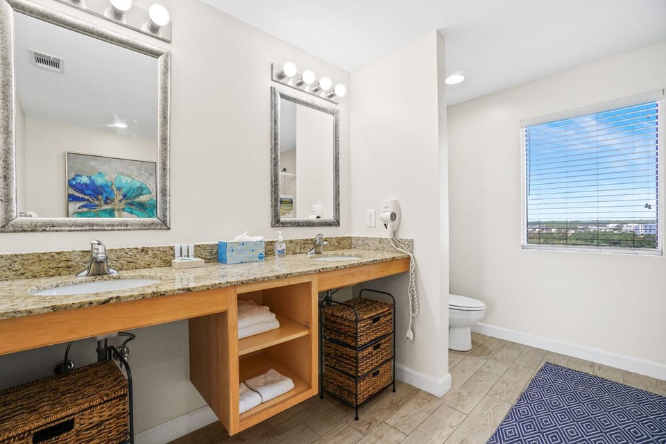 Freshen up in your spacious bathroom with granite counters, ample storage, and natural light streaming through the window.