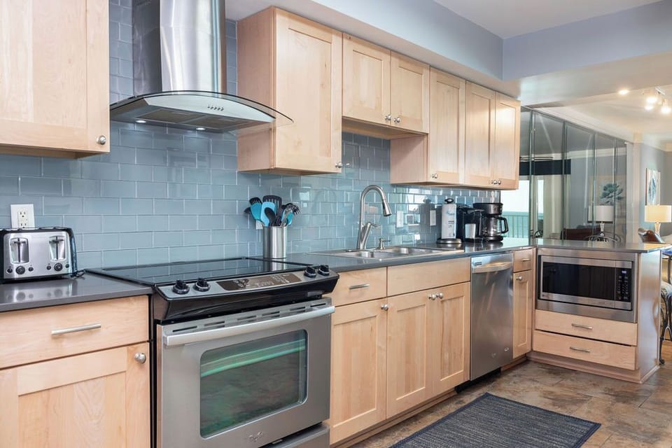 Kitchen - The fully stocked kitchen features stainless appliances, with each drawer and cabinet offering all you need for preparing meals during your stay.