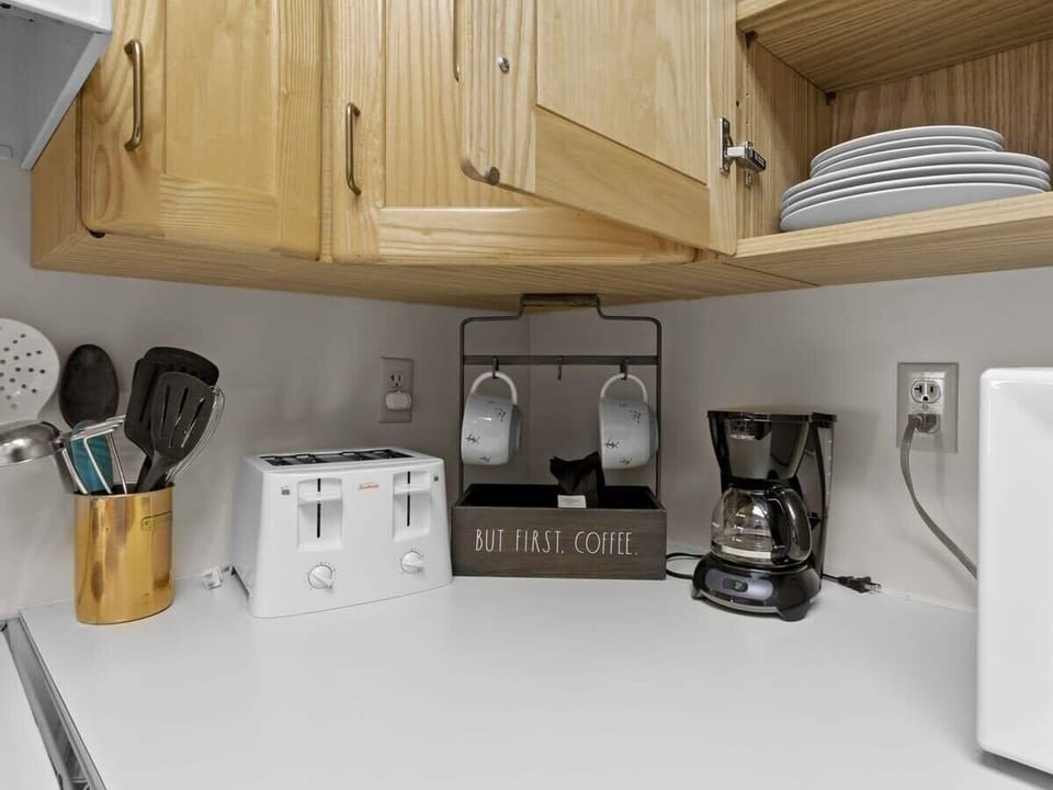 The kitchen features a wide range of appliances for your convenience, including a crockpot and two types of coffee makers.