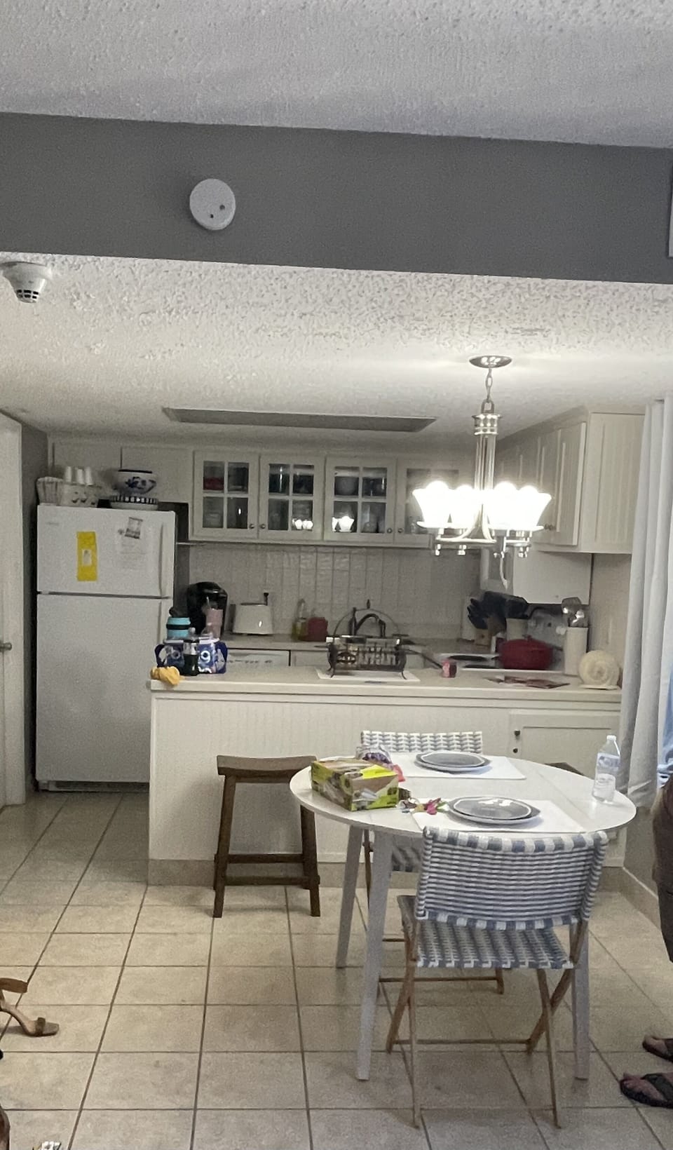 Kitchen with 2 bar stools and round dropleaf table and 2 chairs 
