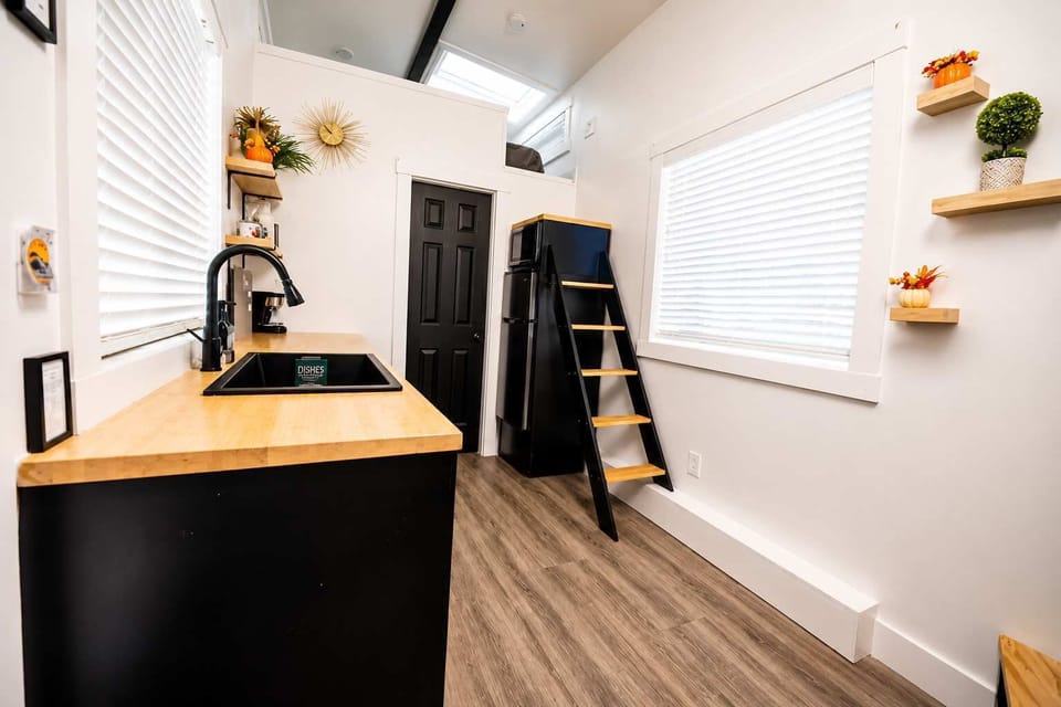 The bright, functional kitchen flows seamlessly into the home's open layout, with easy access to the loft and everything you need for a comfortable, extended stay.