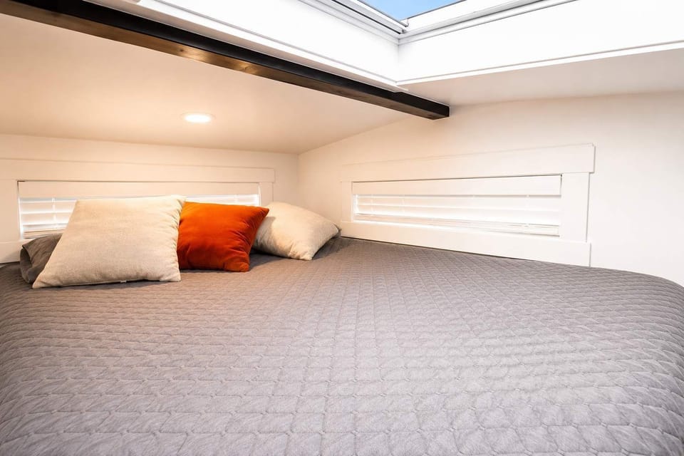 Wake up beneath the skylight in the inviting loft bedroom, where the queen bed offers a cozy place to relax, recharge, and unwind after a day of Southern Utah adventures.