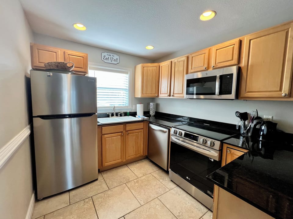 Fully furnished kitchen with stainless steel appliances.
