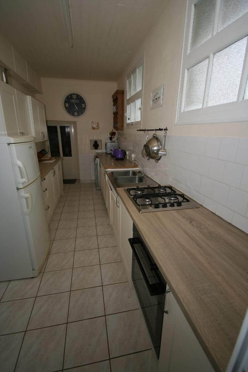 Galley kitchen with gas hob, electric oven and dishwasher