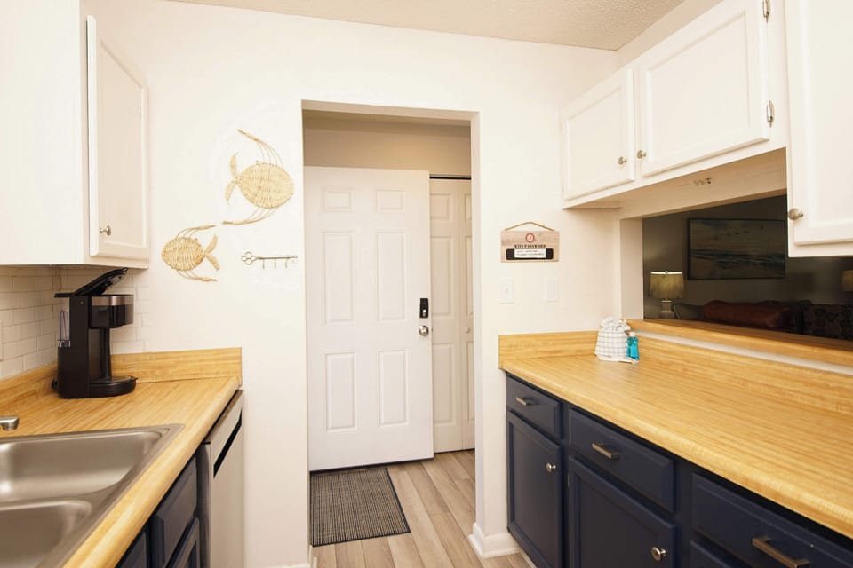 Your bright, coastal-themed kitchen features warm wood counters, nautical touches, and everything you need to prepare delicious meals.