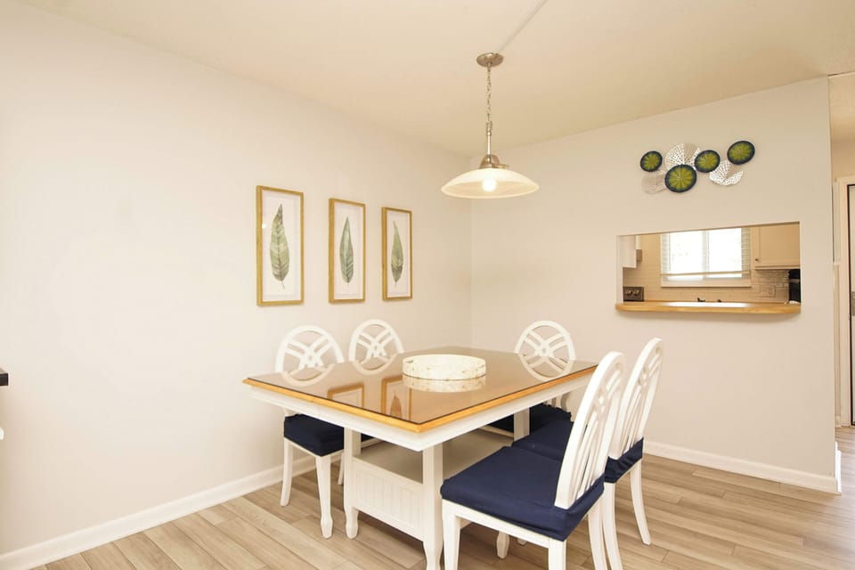 Gather around your elegant dining table for memorable meals, with charming botanical artwork creating a warm, inviting atmosphere for every occasion.