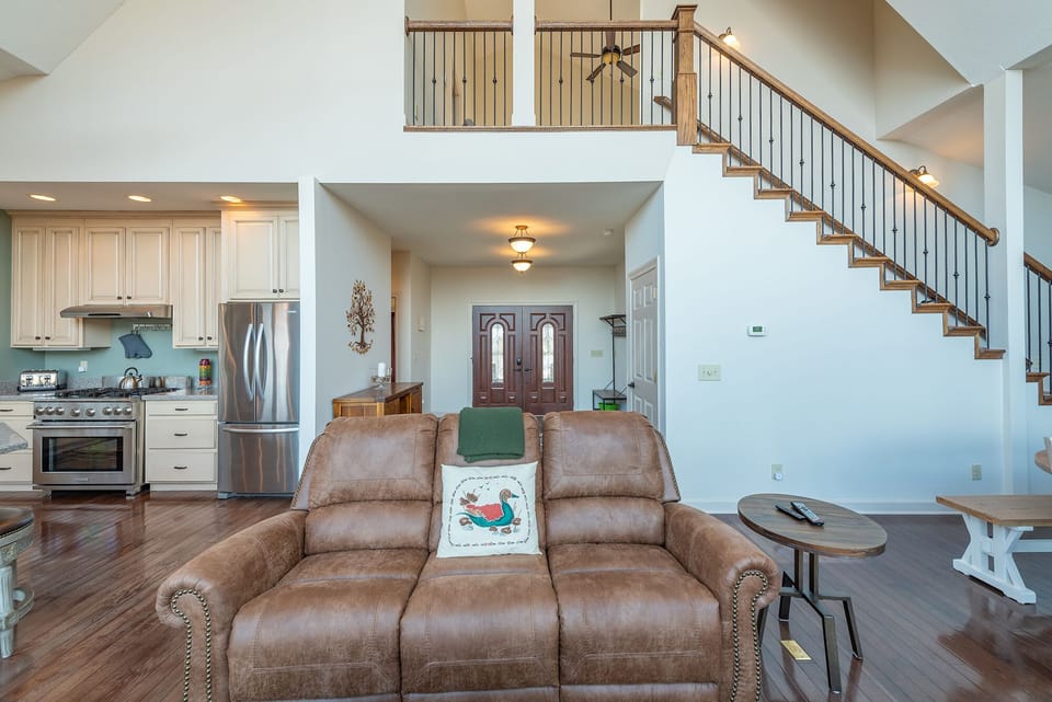 The main entrance leads to the open kitchen, living, and dining areas.