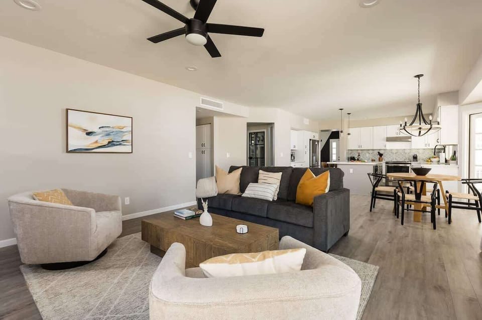 Open living room with designer furnishing and a smart TV.