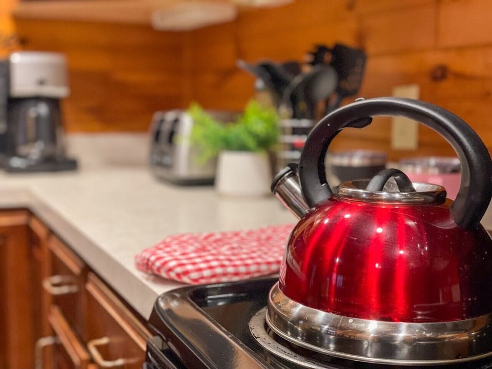 Fully stocked kitchen — kettle on, everything you need for a cabin breakfast