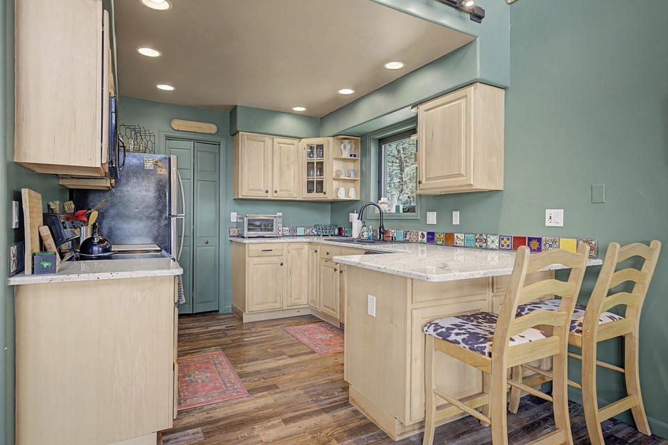 In the Kitchen, there is plentiful counter space and high-top seating for two at the bar.
