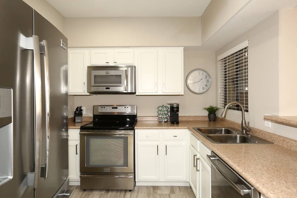 Kitchen with microwave, stove/oven, fridge, dishwasher, utensils etc