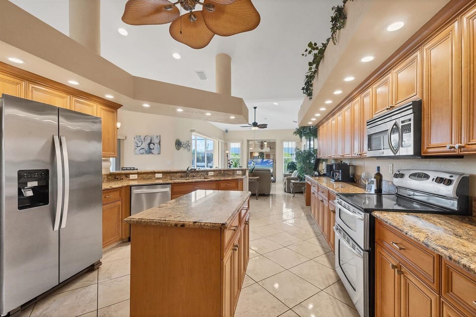 Large, open, fully-equipped kitchen overlooking breakfast table & living room