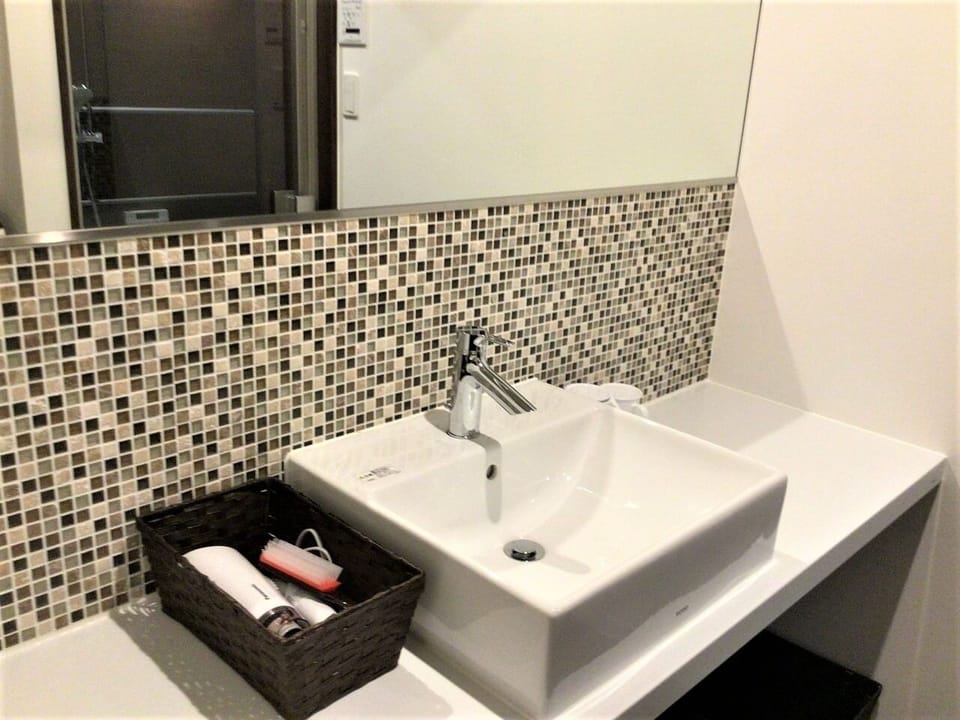 A spacious and bright bathroom with a large mirror