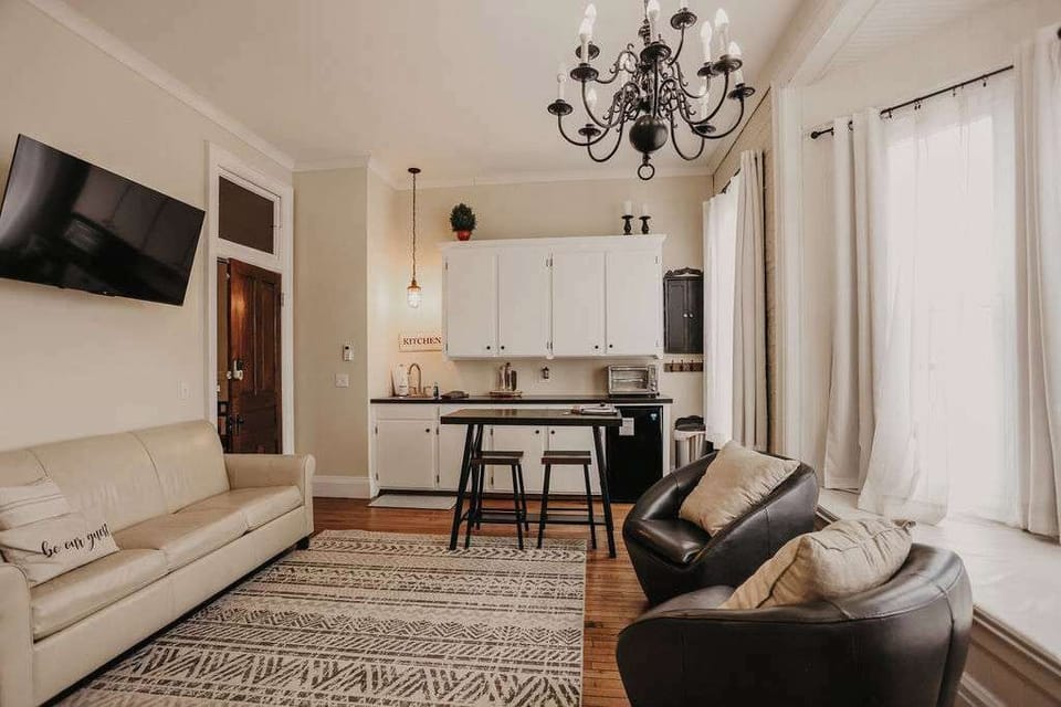 East Suite leather sofa bed in cozy living room – versatile sleeping space at Sleep Suites in Downtown Clare MI, perfect for weekend getaways and family stays.