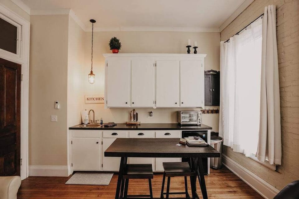 East Suite compact kitchen with bar‑height two‑seat table – well‑equipped Clare MI vacation rental kitchenette for simple meal prep and relaxed evenings in
